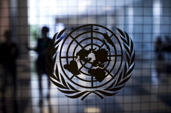 A United Nations logo is seen on a glass door in the Assembly Building at the United Nations headquarters in New York City September 18, 2015. REUTERS/Mike Segar